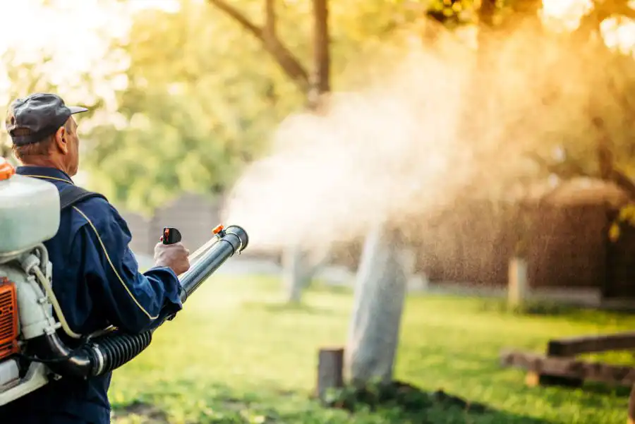 A pest control technician spraying outdoors for mosquitoes - Keep mosquitoes away from your home with Florida Pest Control in Gainesville FL
