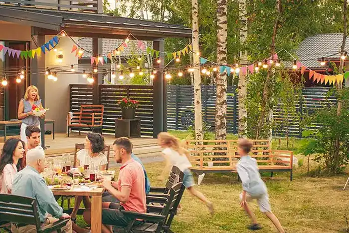 A family eating dinner outside on an outdoor patio - Keep mosquitoes away from your home with Florida Pest Control in Gainesville FL