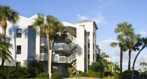 Florida multifamily community with water features and palm trees, at risk for pest activity during hurricane season.