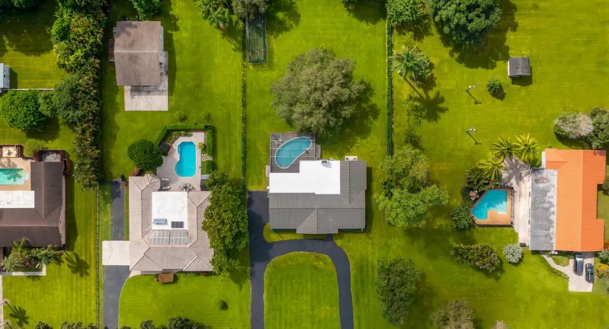 aerial drone of florida homes with pools and gardens