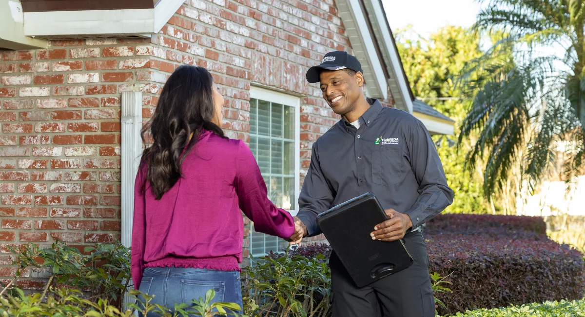 technician showing tablet to home owner