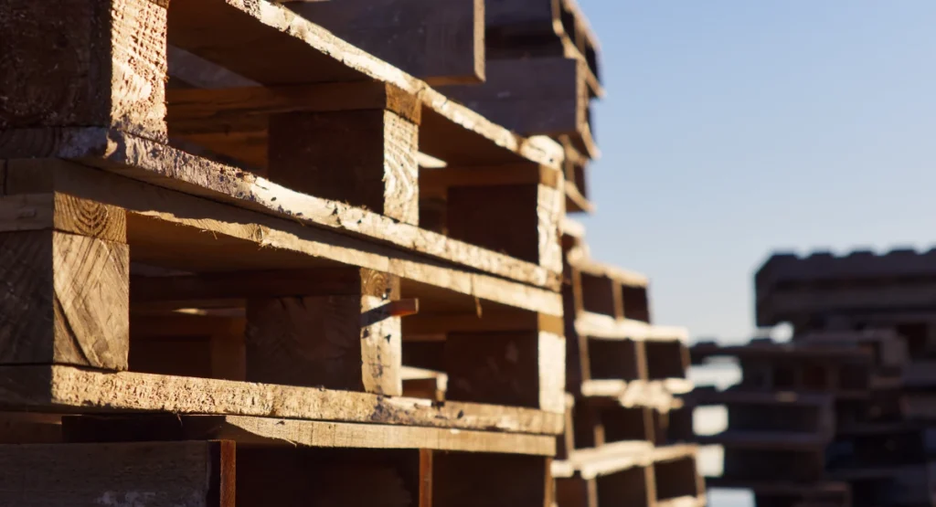 stacked wooden pallets in industrial setting