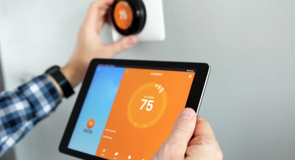 A man adjusting the temperature on a smart home app