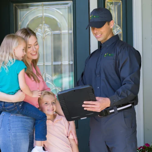 Florida pest tech showing customer and family tablet outside home