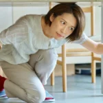 a woman hiding under the desk