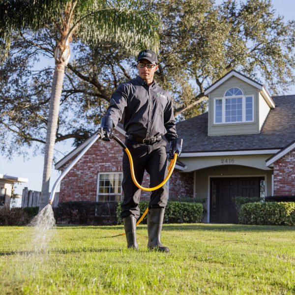 Florida Pest colleague spraying perfect looking lawn
