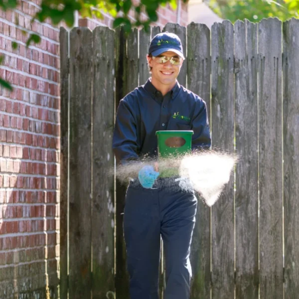 A Florida Pest technician with a liquid spray