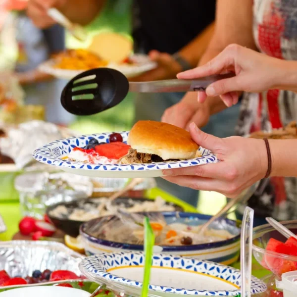 Close-up of open food on tables at an outdoor picnic